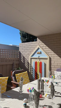 Cozy backyard birthday party setup with vibrant chairs and tables