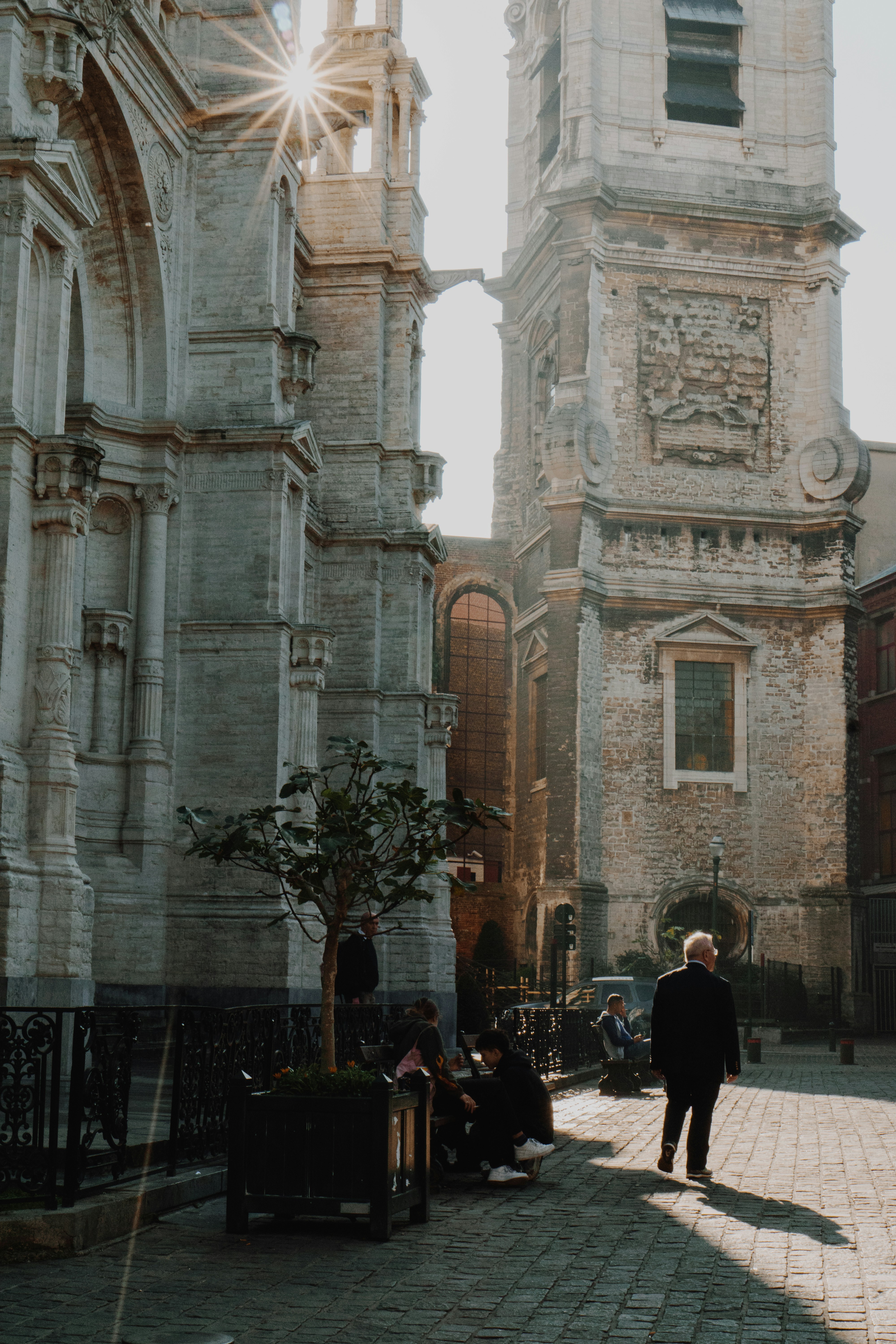 man standing near white concrete building