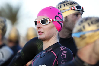 selective focus photography of woman wearing swimming cap