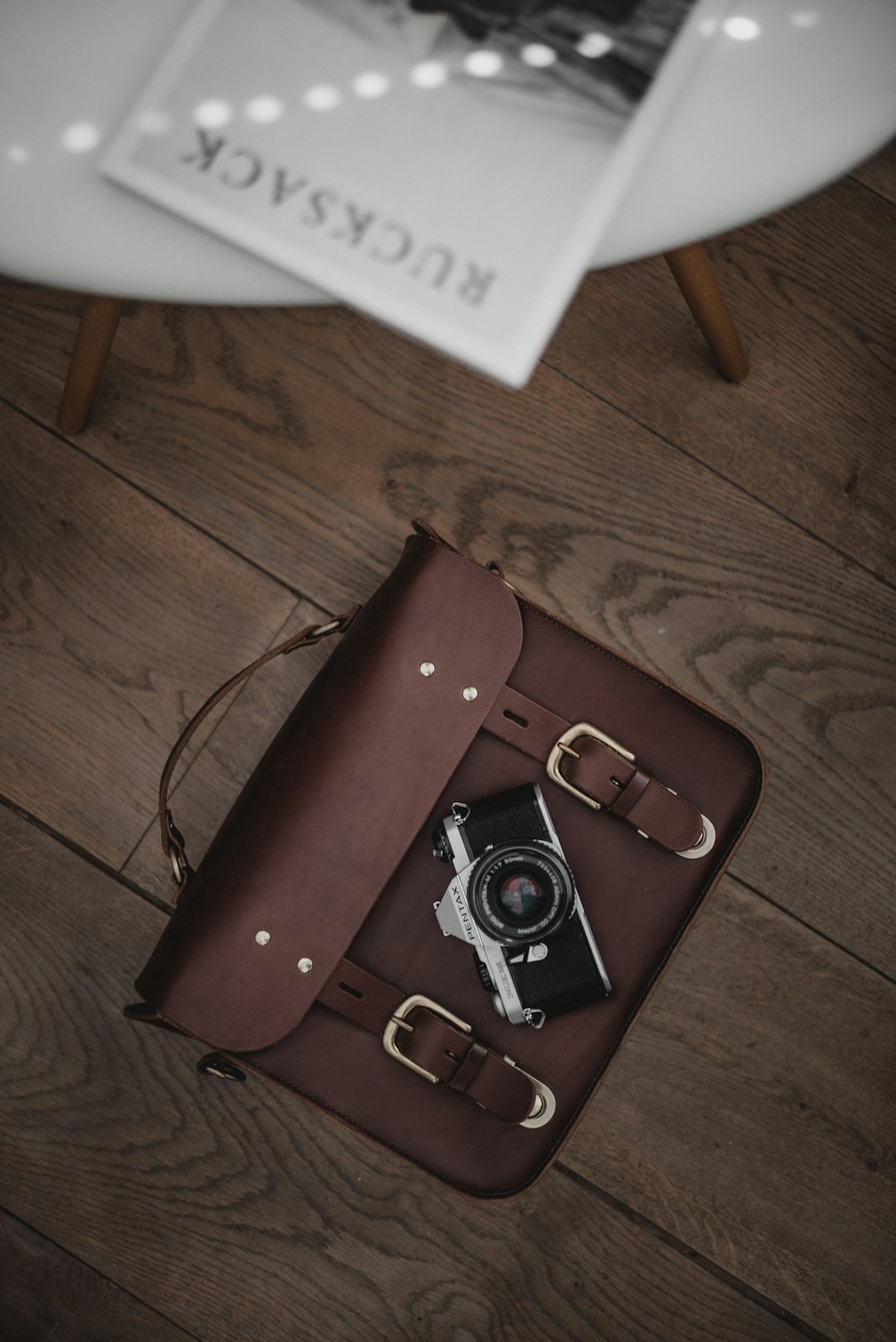 brown leather case on brown surface