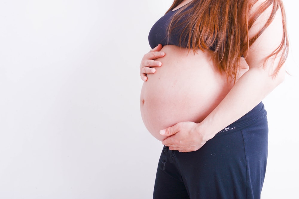 pregnant holding her tummy