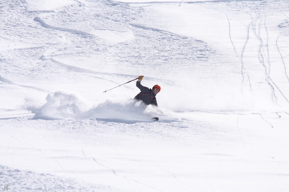 person skiing down slope during daytime
