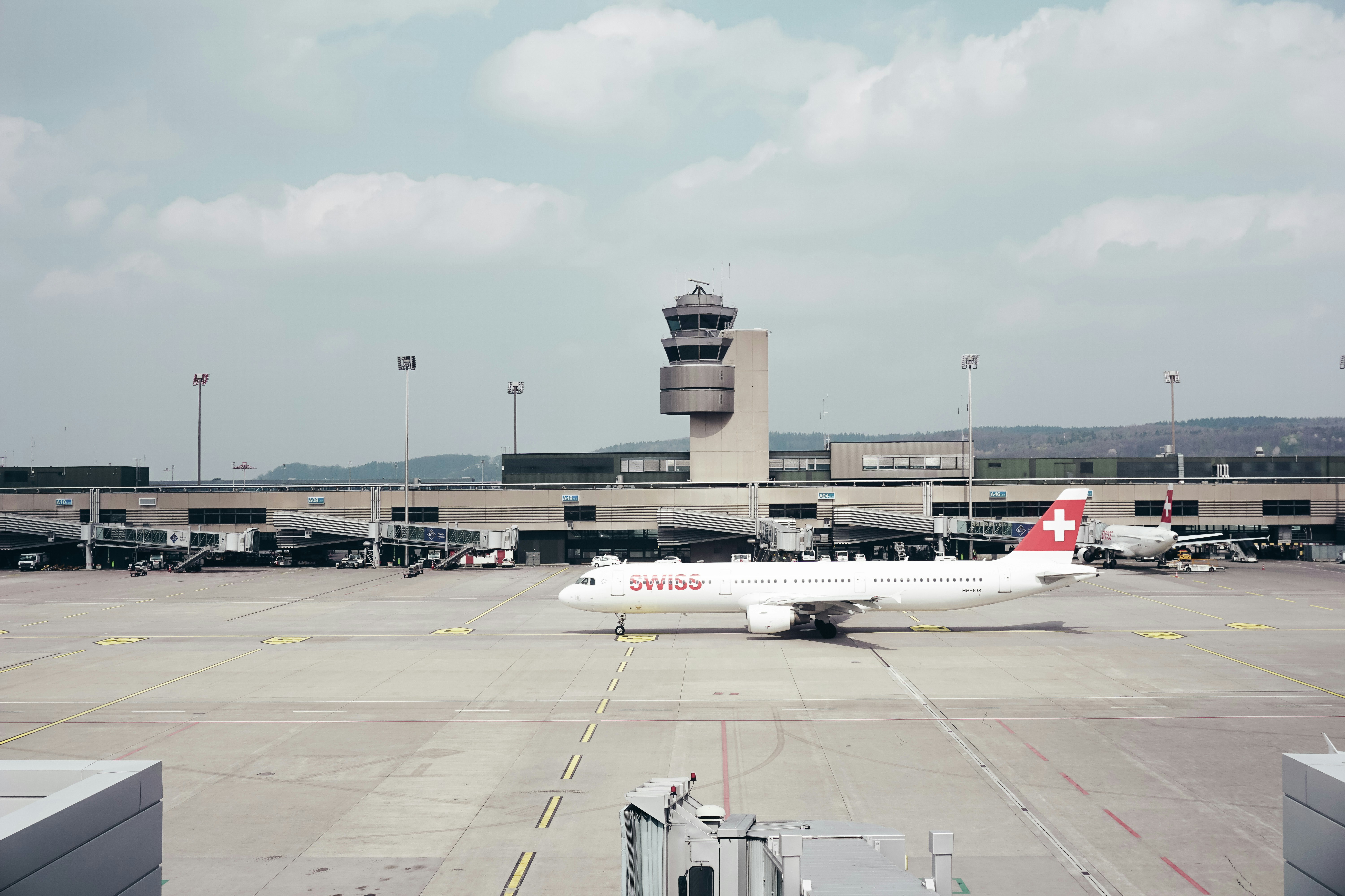 white and red plane landed on airport, 