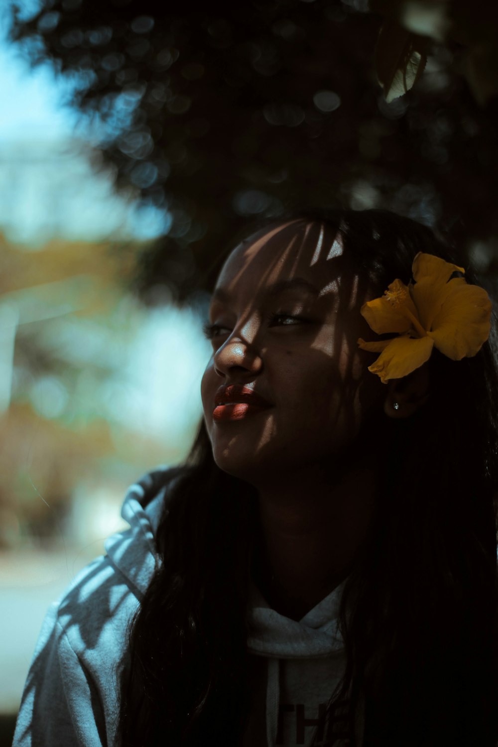 selective focus photo of woman under tree