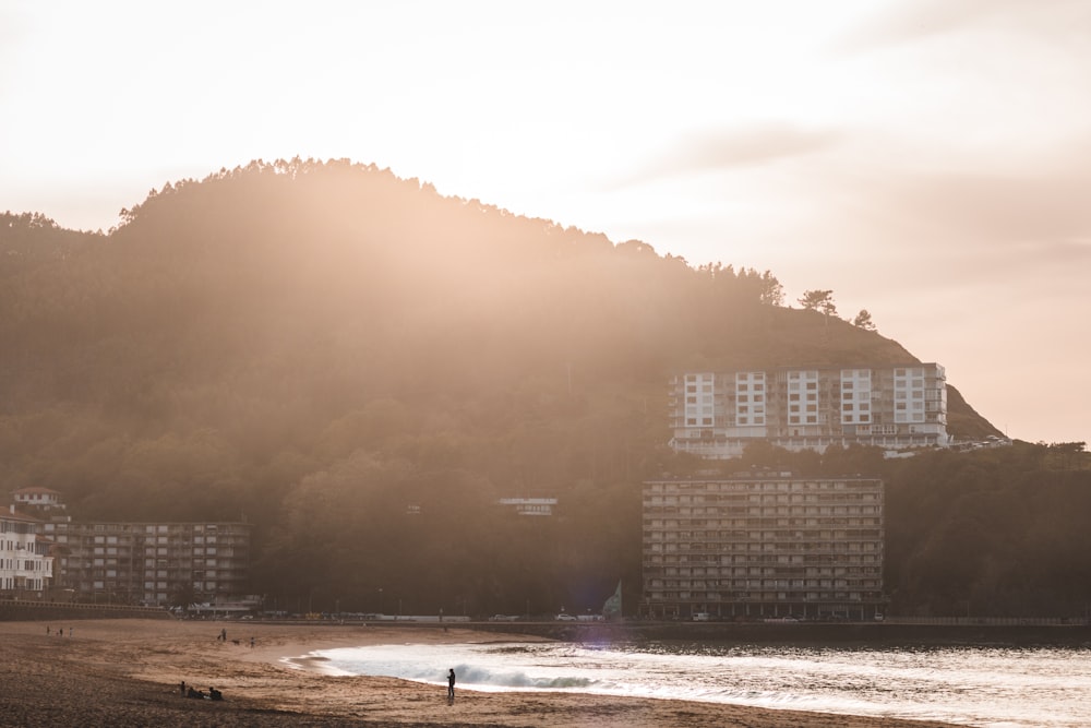 white concrete building on mountain side during golden hour