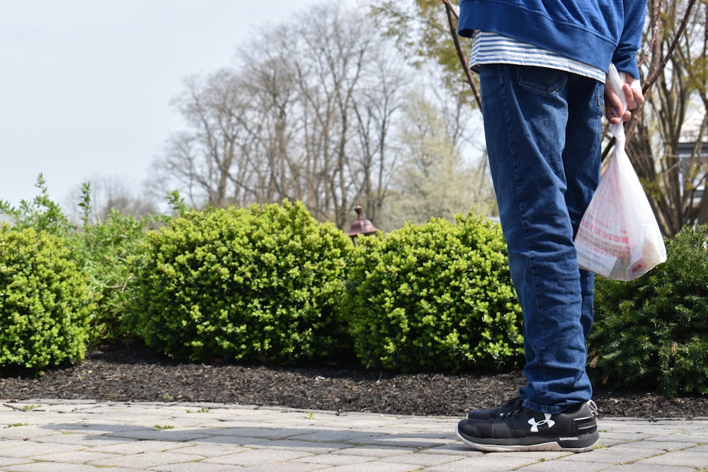 person standing near bushes