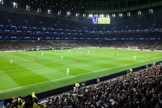 two teams playing soccer inside stadium