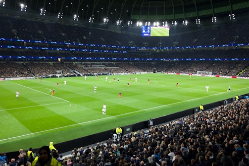 two teams playing soccer inside stadium