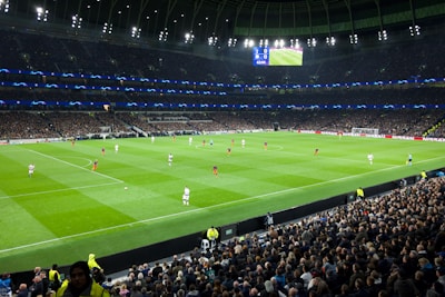 two teams playing soccer inside stadium