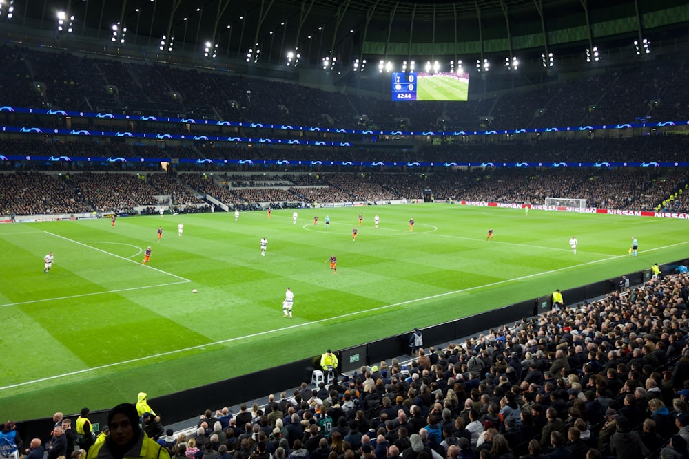 two teams playing soccer inside stadium