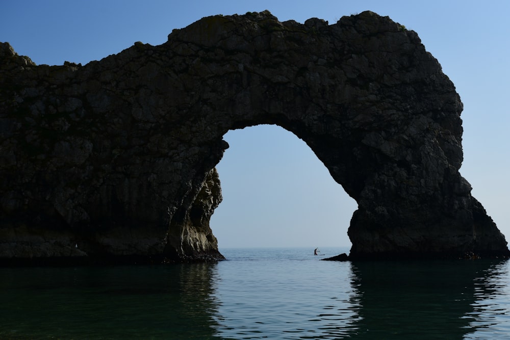 arc rock formation at middle of sea