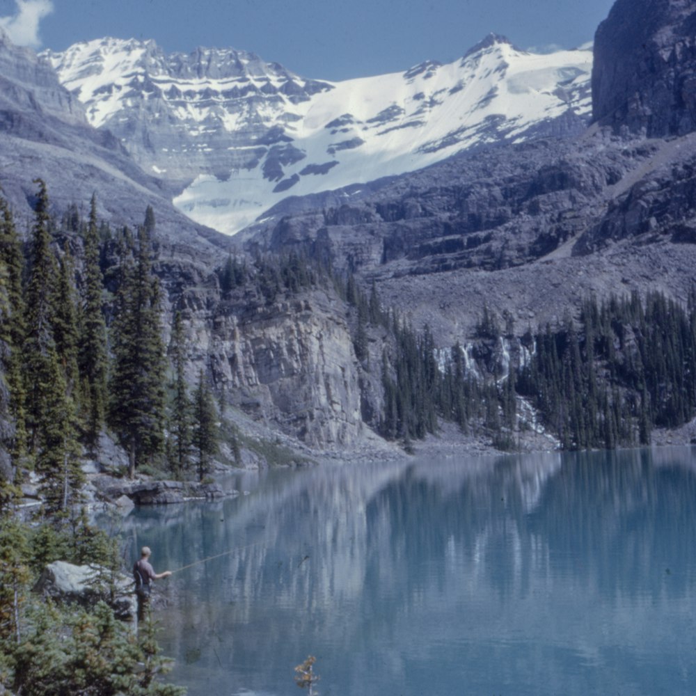 man fishing on lake