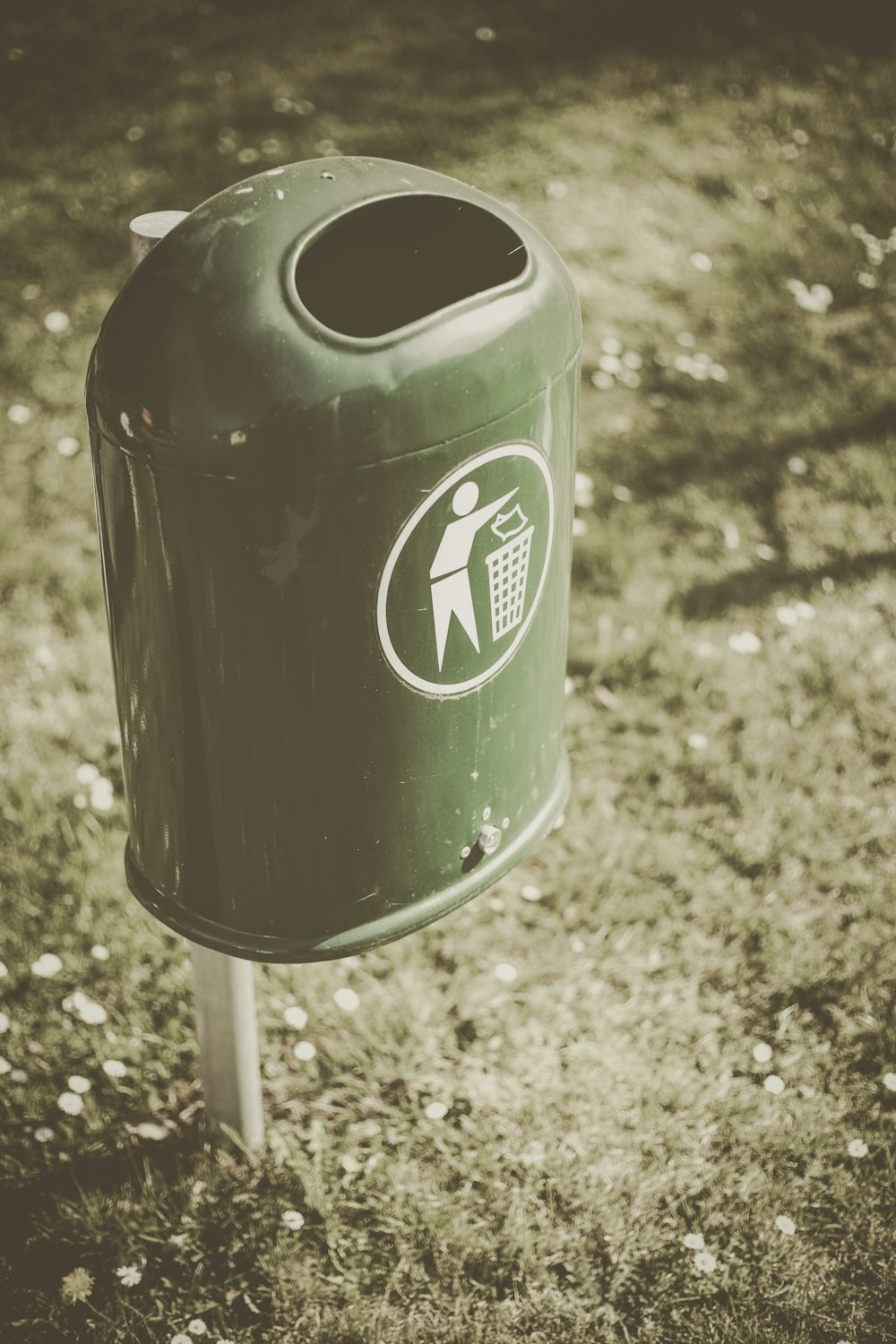 selective focus photo of green trash bin