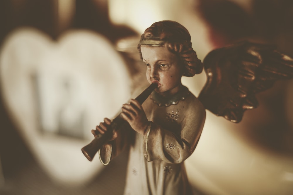 brown ceramic angel playing flute figurine