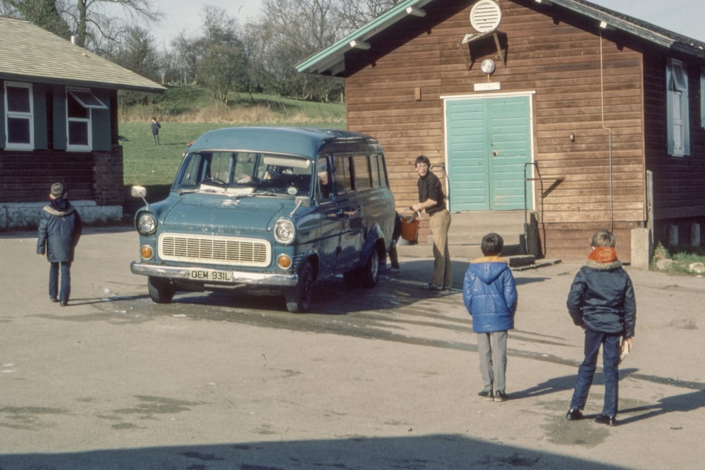 blue vehicle parked near house