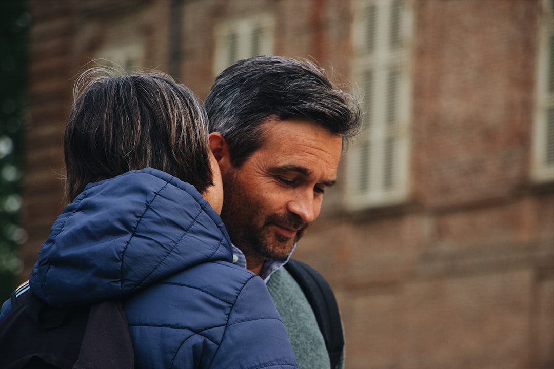 selective focus photo of woman whispering to the man