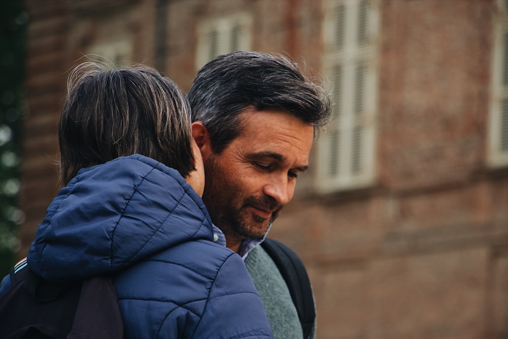 selective focus photo of woman whispering to the man