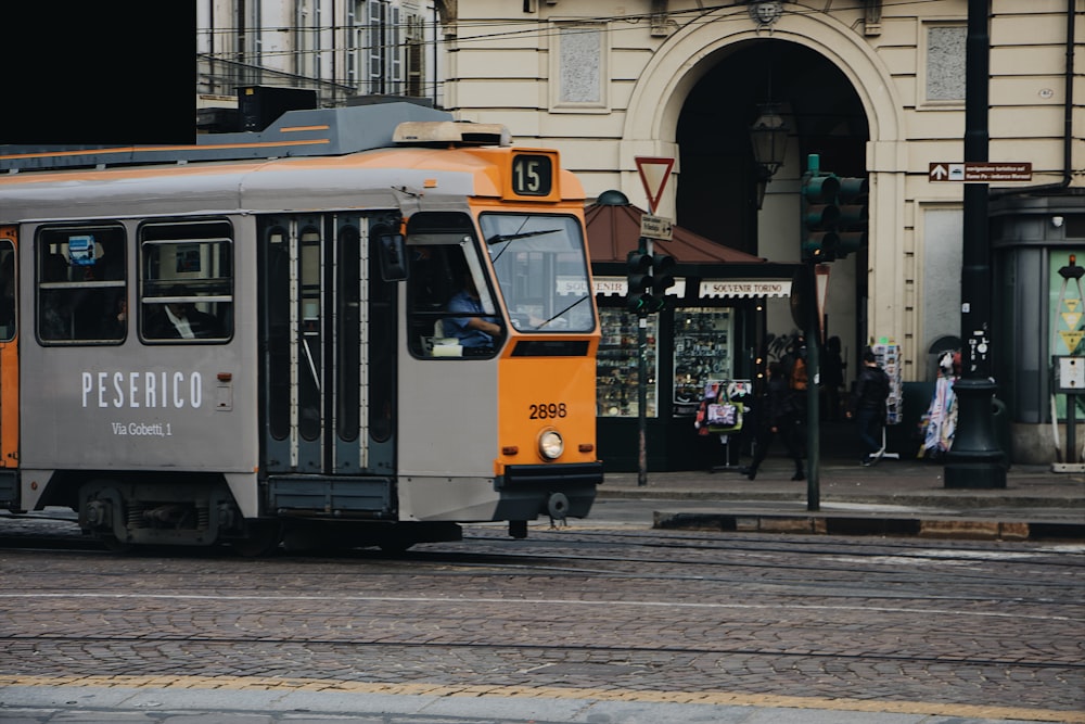 Peserico tram passing near white painted building