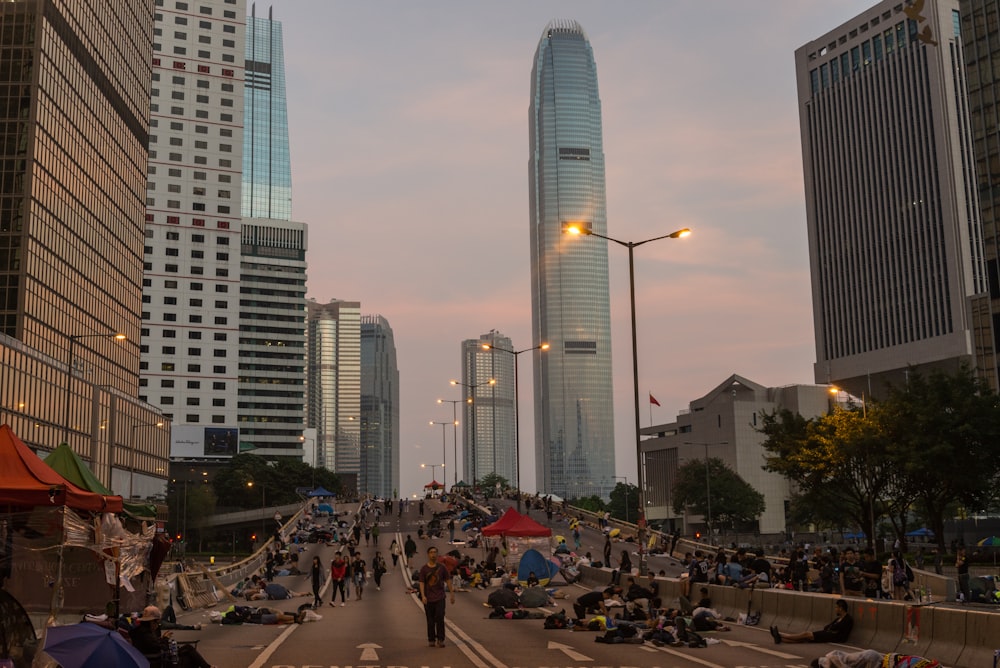 people on road near high-rise building