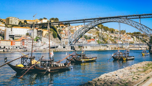 Boat sailing near bridge — Porto, Portugal