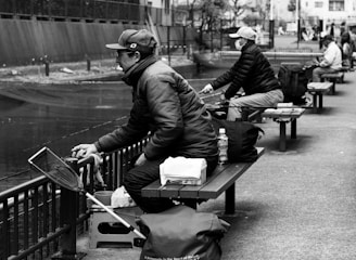 A friendly meeting of anglers sharing tips and stories by the water.