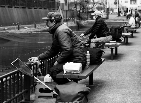 A friendly meeting of anglers sharing tips and stories by the water.