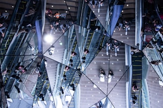 people at the mall reflection on mosaic glass panel
