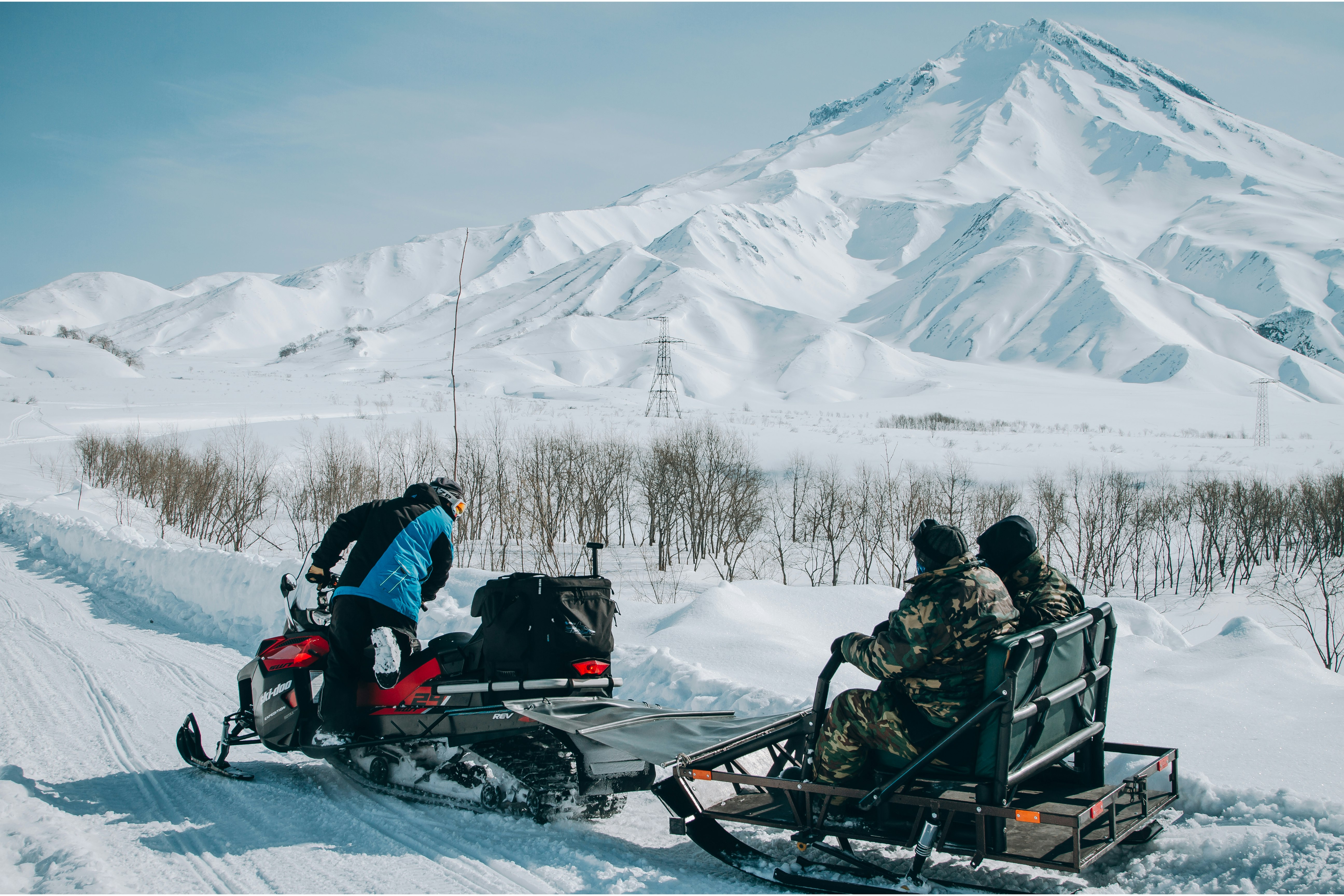 person riding snow mobile with trailer