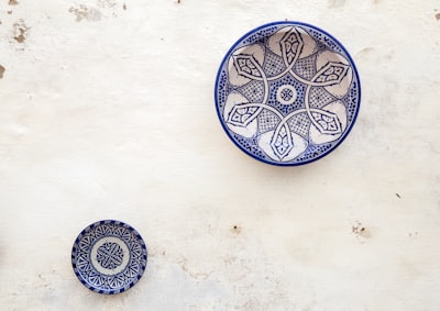 two white-and-blue ceramic dinnerware gleaming zoom background