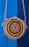 Close-up of a vibrant handmade beach bag hanging on a wooden beach chair.