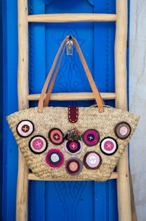 brown leather tote bag hanging on wall