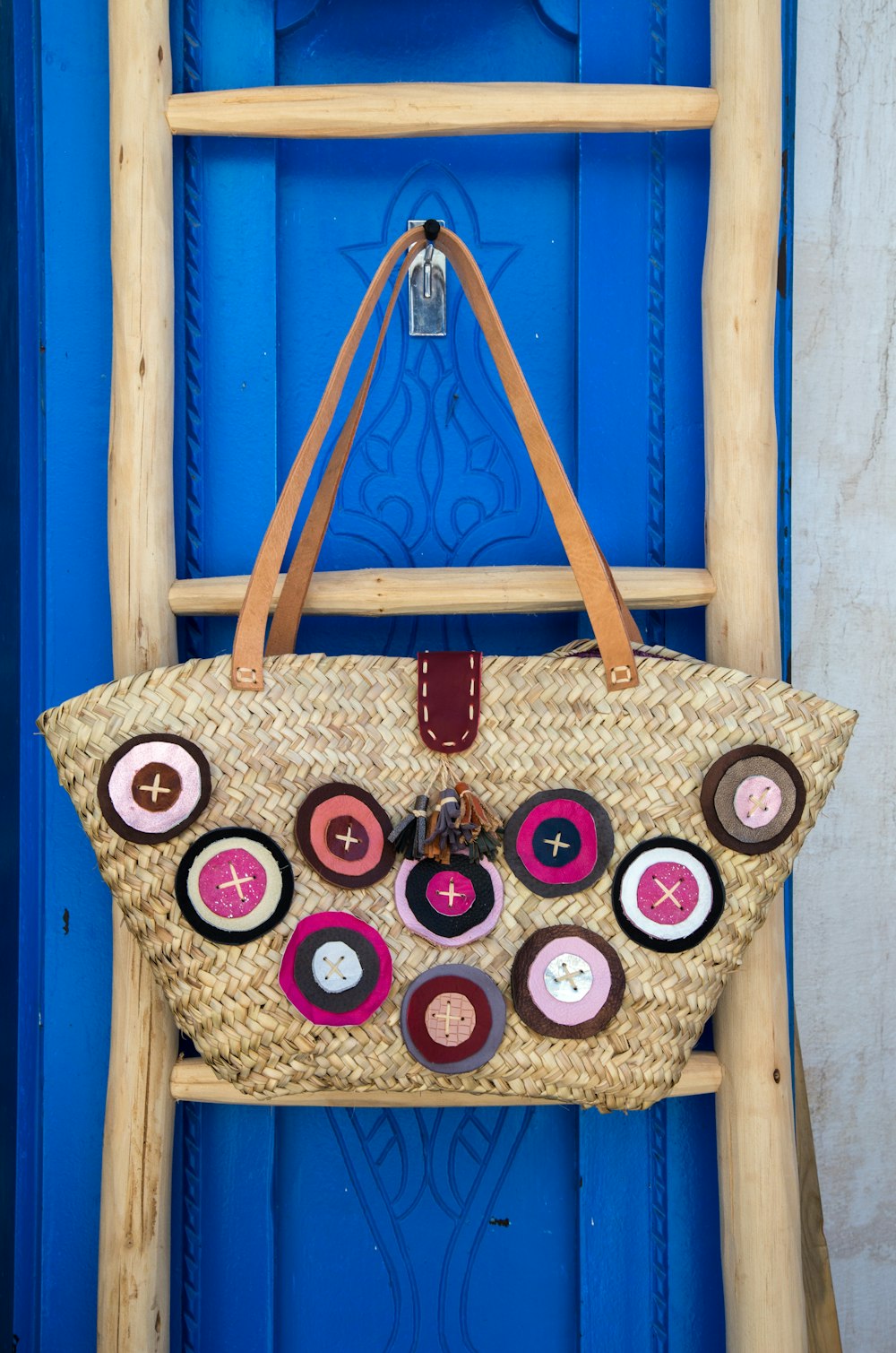 brown leather tote bag hanging on wall