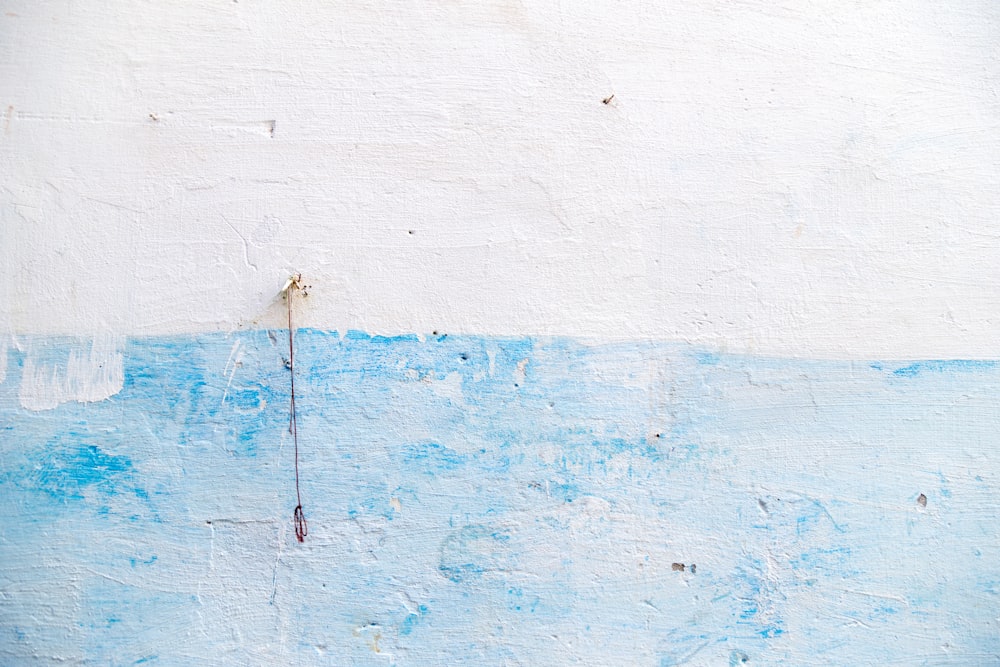 a blue and white wall with a red fire hydrant