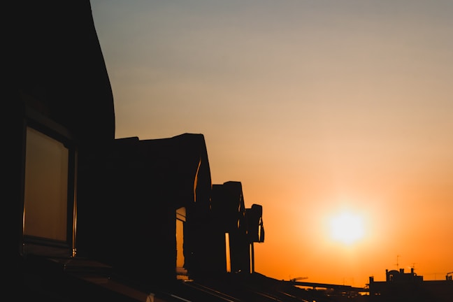 Golden sunset casting warm light over Vilnius Old Town rooftops.