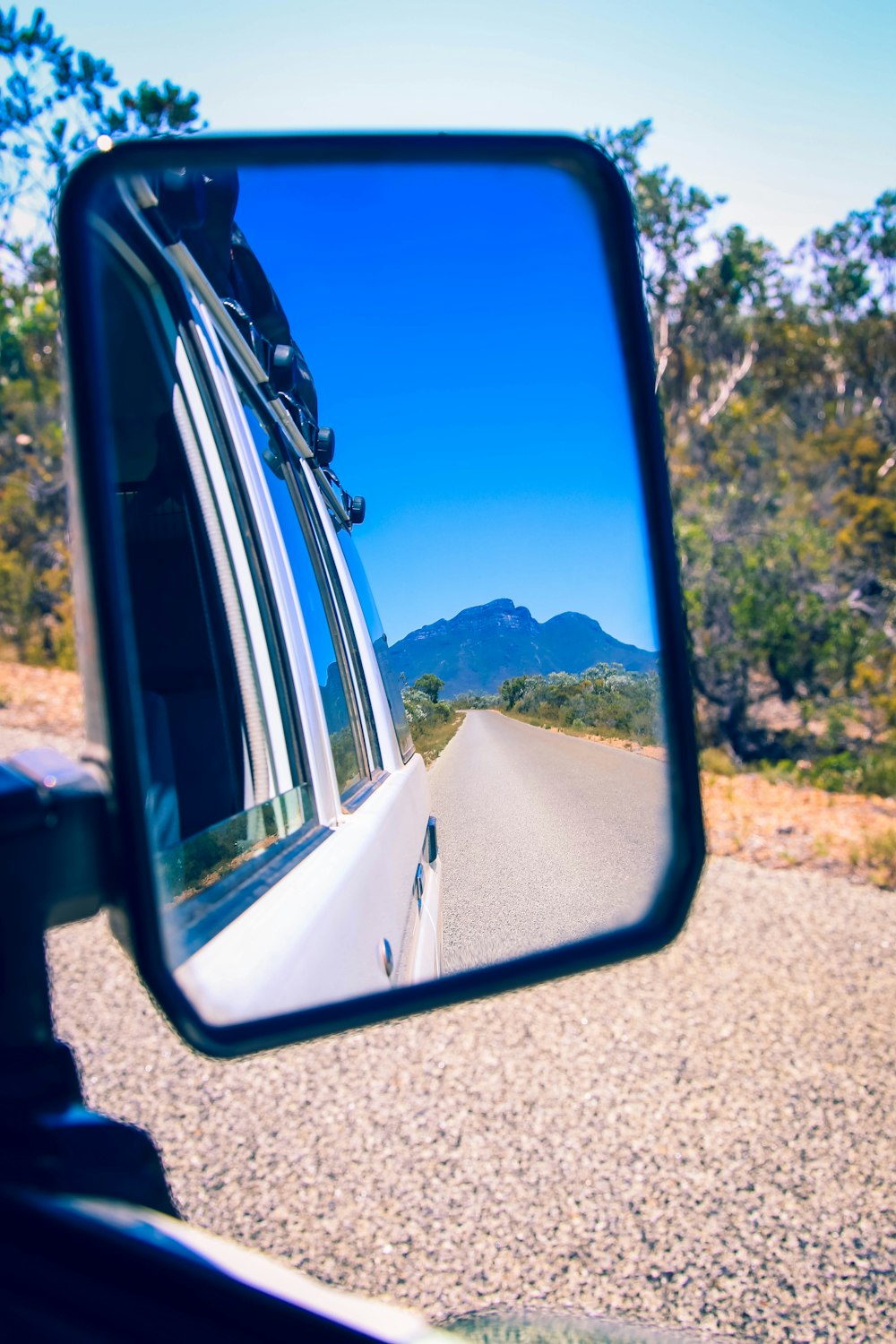 reflectio of road on vehicle's wing mirror