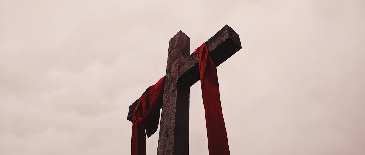 low angle view of cross with red garment