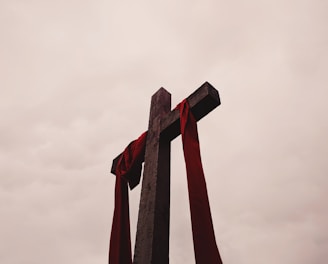 low angle view of cross with red garment