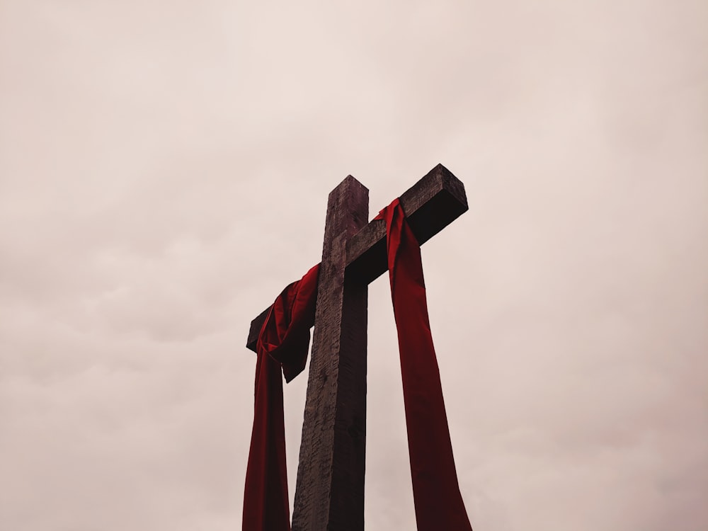 low angle view of cross with red garment