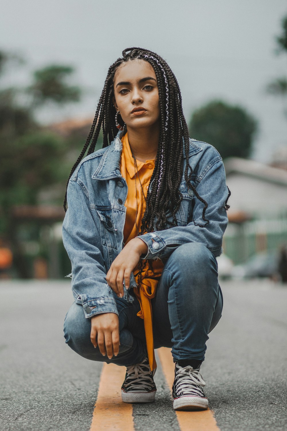 woman squatting in the middle of road