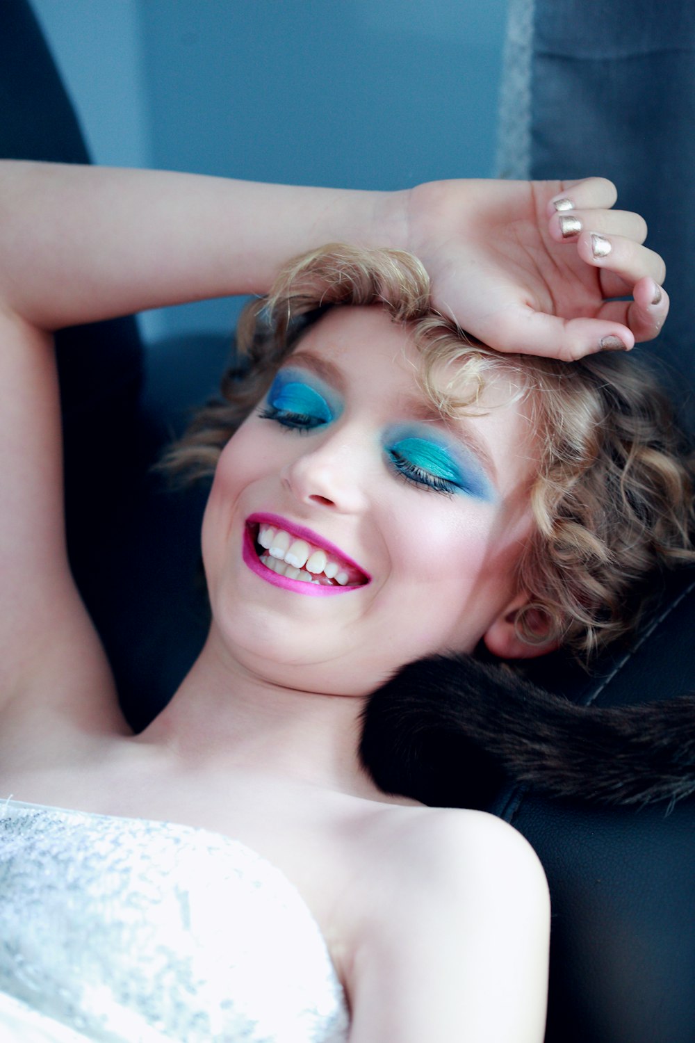 smiling woman lying and putting right hand on her head