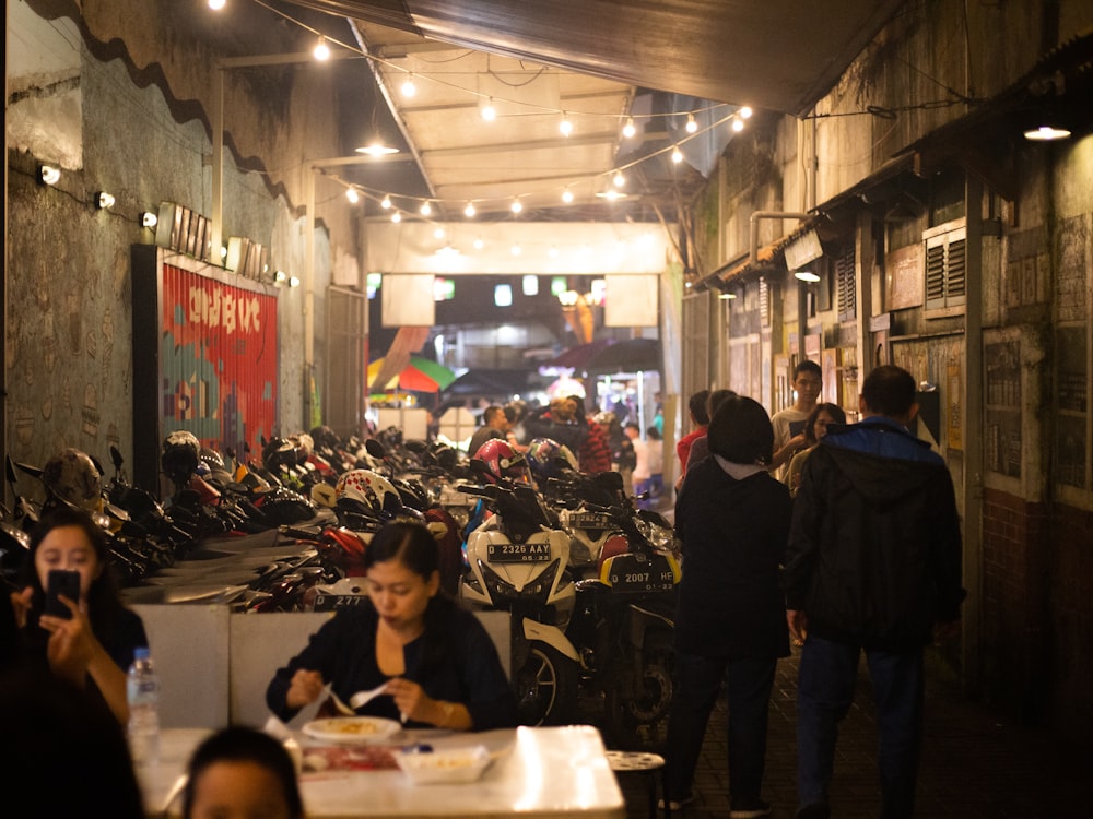 people standing near motorcycle parking lot