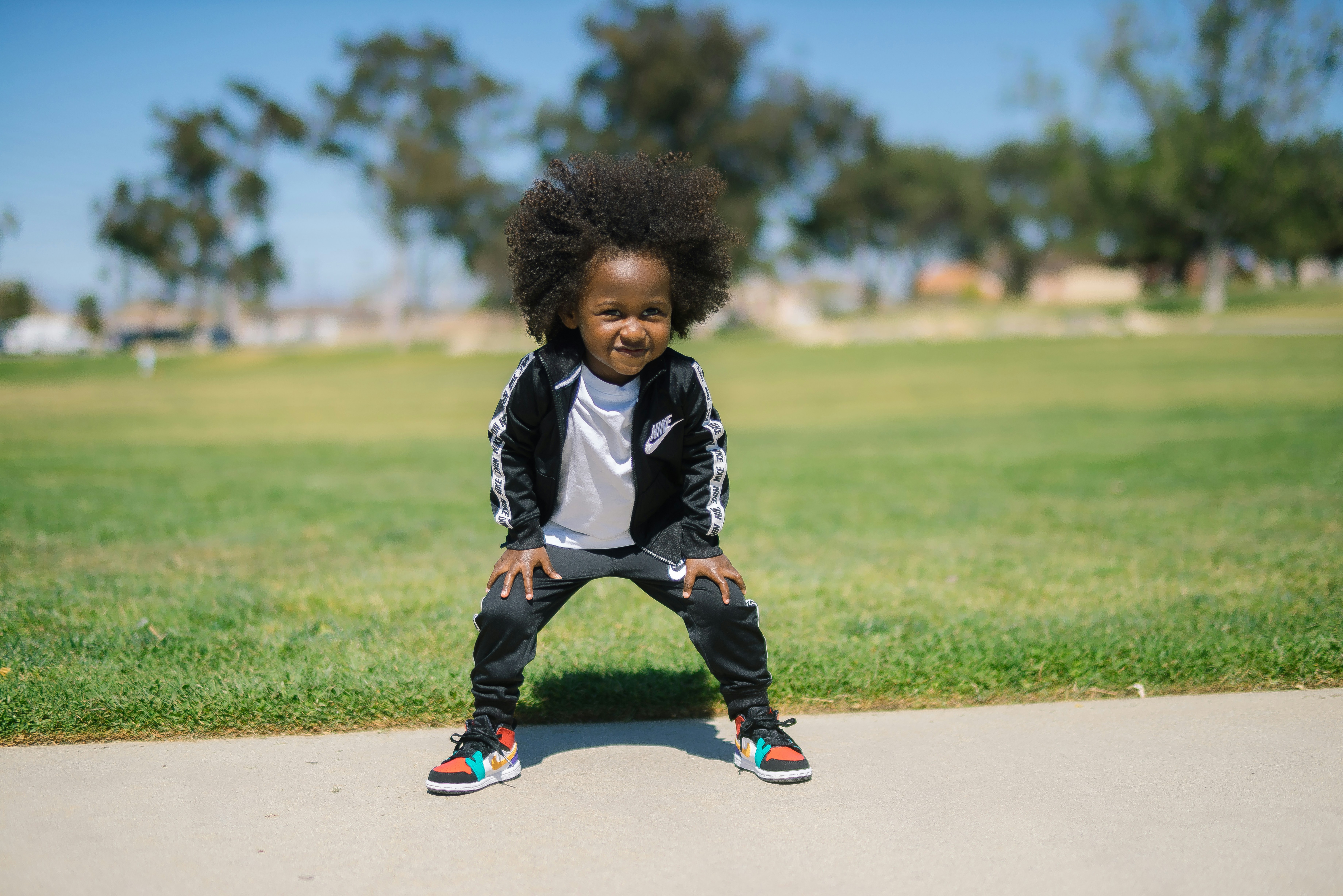 Little girl standing on sidewalk