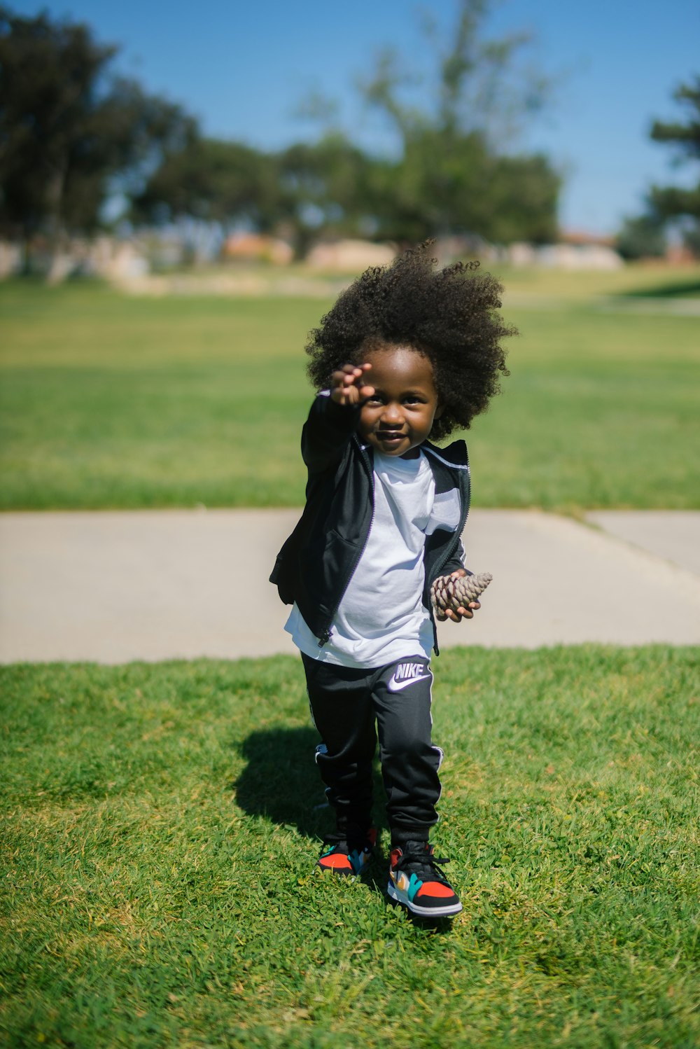 child standing on grass field