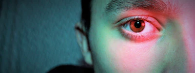 Close-up of a facial recognition system analyzing a subject with saffron and green accent lighting.