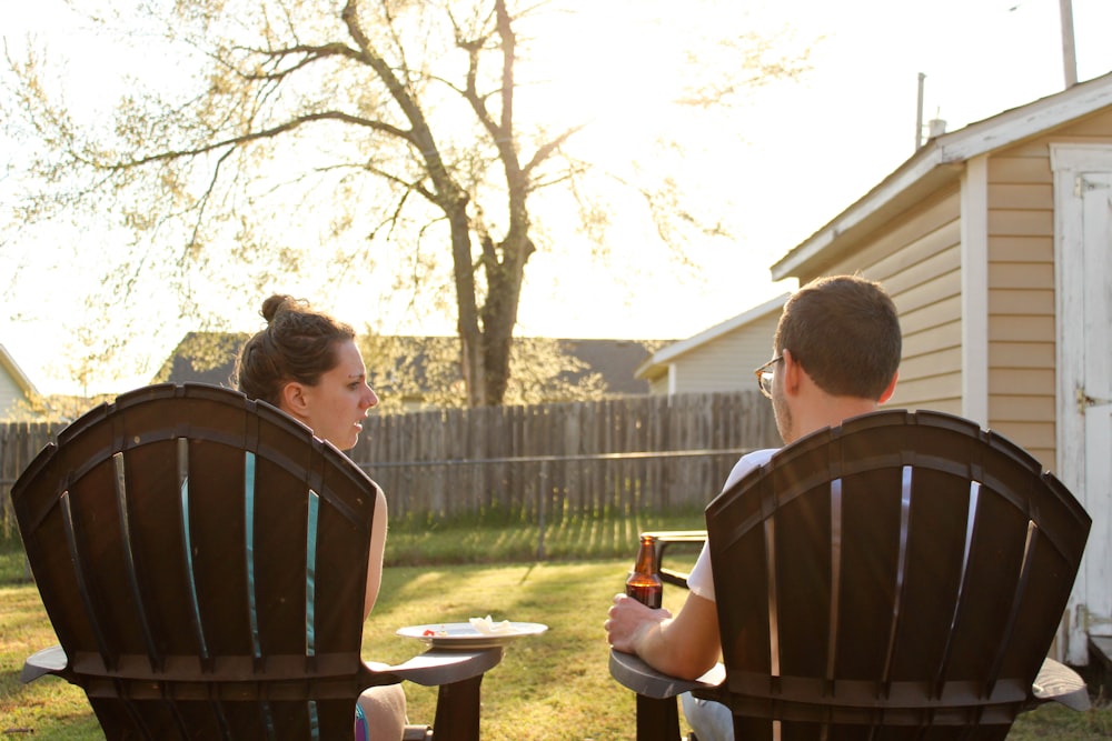 a couple of people sitting in lawn chairs