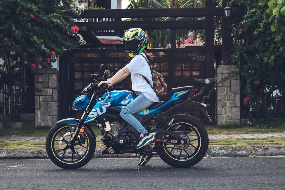 person riding on blue sports bike