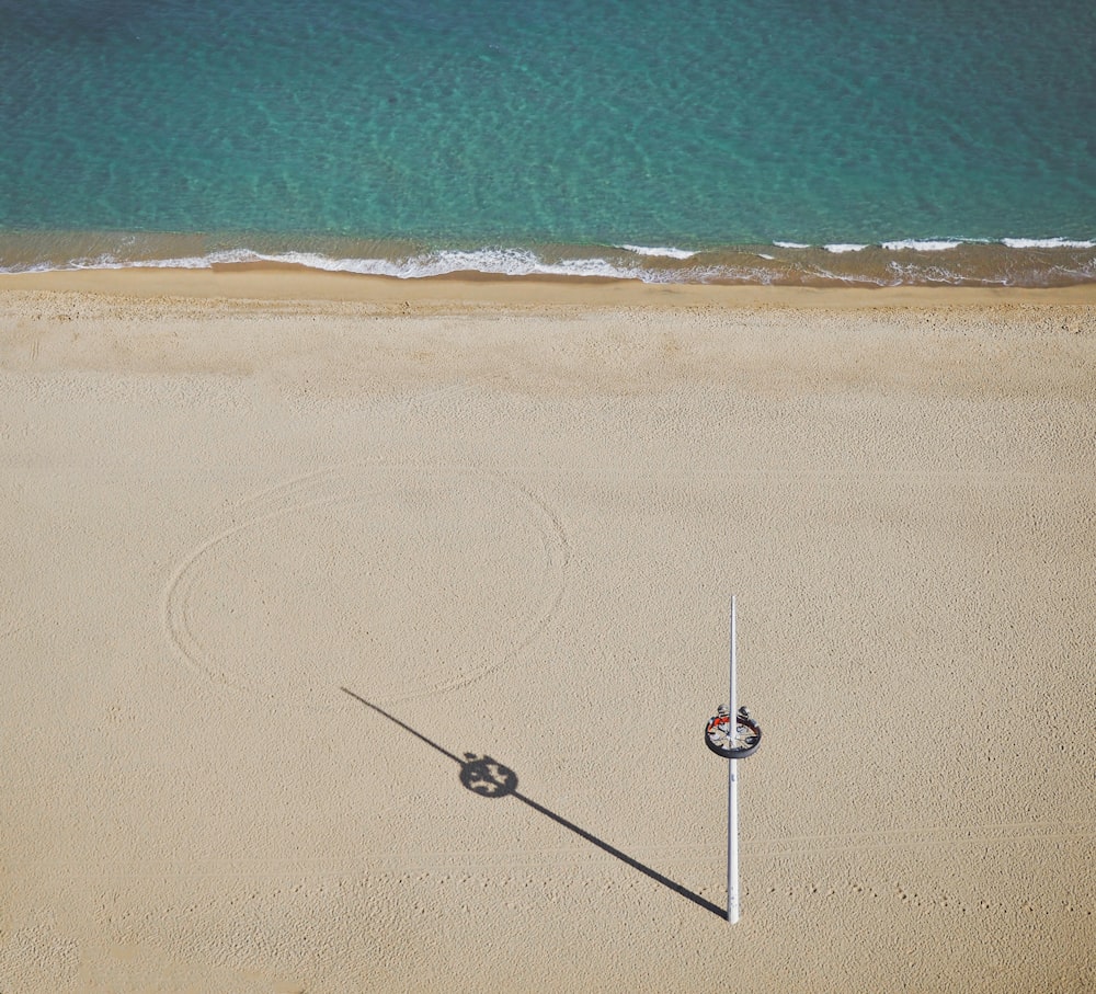 white pole near ocean