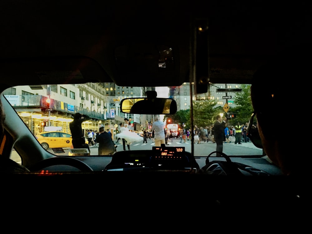 men on street through car's windshield
