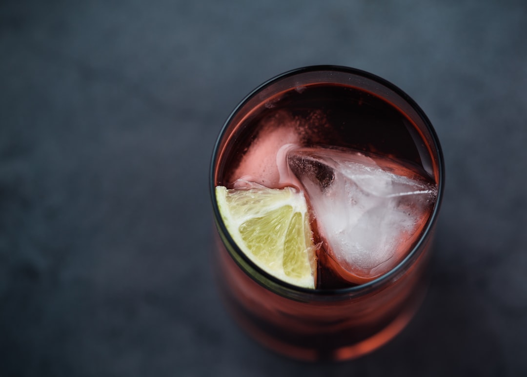 filled clear rock glass with ice and sliced lemon