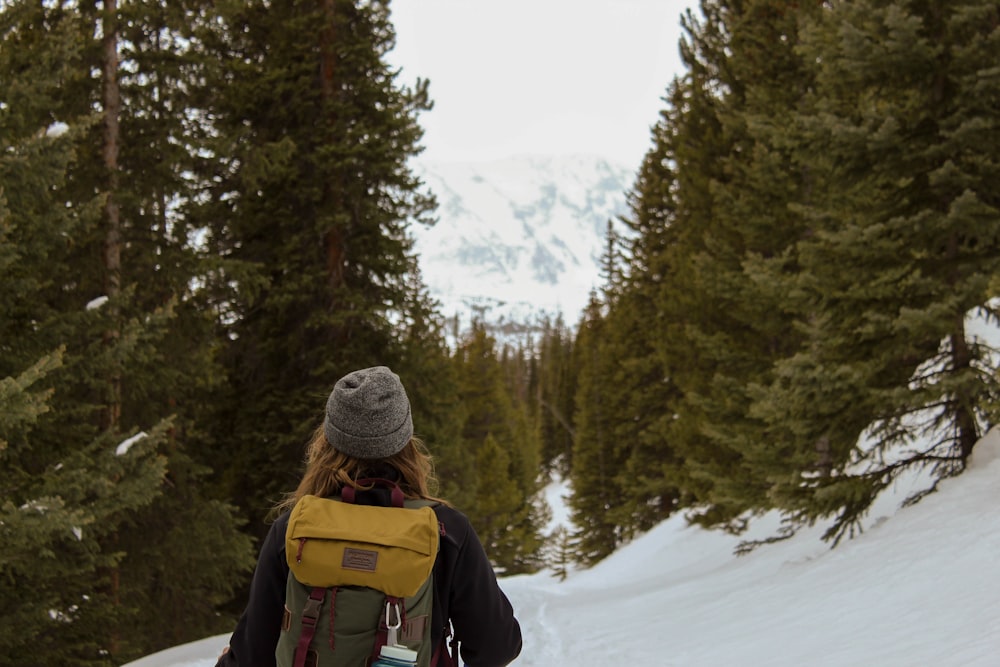 woman standing near pine trees